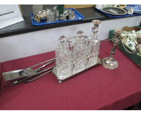 A Silverplate Tantalus Holding Three Cut Glass Decanters, three piece fire companion set and and EPNS three branch candelabra