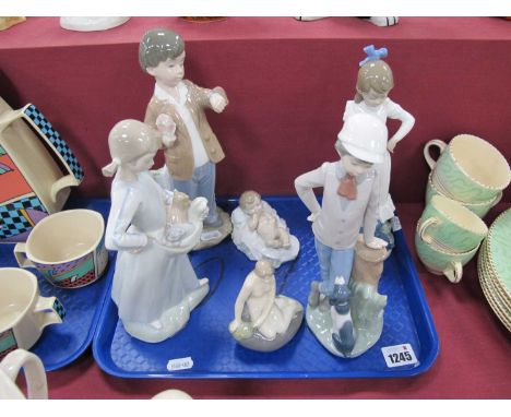 Lladro Nao Figurines, to include boy with dog,. 24cm high, girl with dog, girl with kittens, boy with flowers, baby and one o