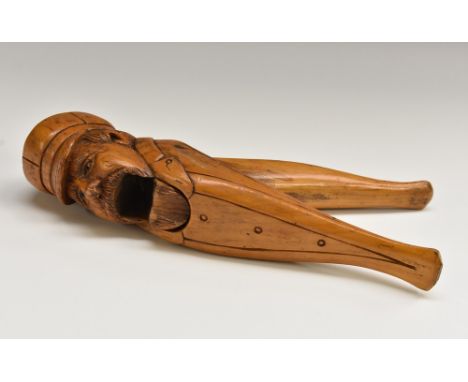 A Black Forest type novelty lever-action nutcracker, carved as a bearded gentleman wearing a cap and a buttoned coat, 19.5cm 