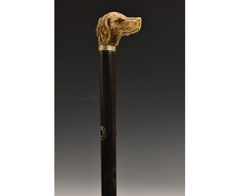 A 19th century ivory gentleman's walking stick handle, carved as the head of a dog, glass eyes, ebonised shaft, 90cm long ove