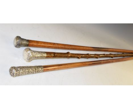 A 19th century Indian silver mounted walking stick, the domed pommel chased with scrolling foliage, 84cm long; others, simila