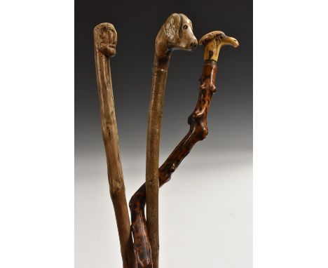 A 19th century folk art hedgerow walking stick, the stag antler handle carved as a stylised head, initialled IE, pyrography s