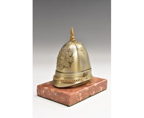 An early 20th century novelty inkwell, as a military pith or sun helmet, rectangular marble base, 11.5cm wide