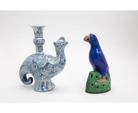 TWO CHINESE CERAMIC MODELS OF BIRDS
A blue and white candlestick; and a blue and green glazed model of a parrot
24cm high
Con