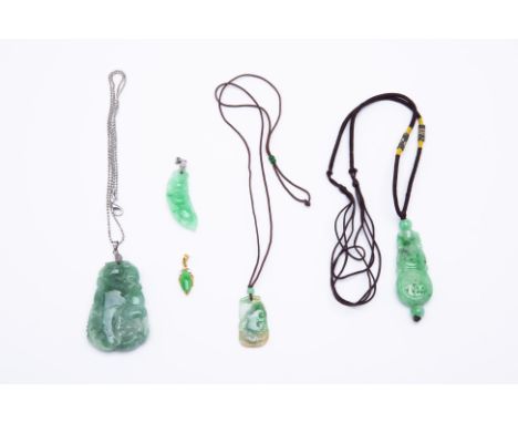FIVE JADE PENDANTS
Two with rope necklaces, the other with a white metal chain, and the small teardrop shaped jade pendant wi