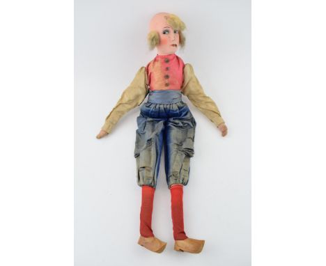 A boudoir doll in the form of a Dutch Lady in clogs. Silk clothes, composition head and hand painted features. Height 59cm.  
