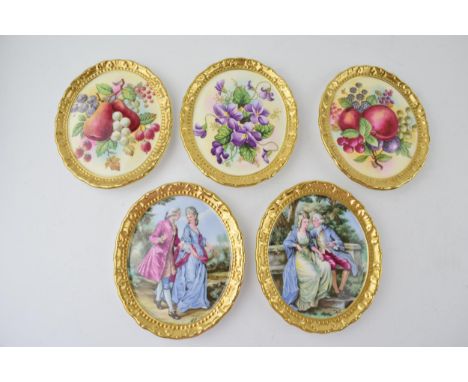 A collection of Paragon gilt decorated painted plaques with romantical scenes and others (5), 13cm tall.  In good condition w