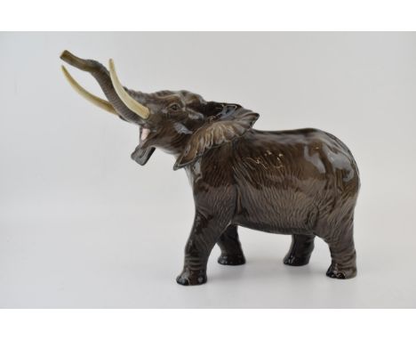Beswick large elephant with trunk up, 35cm long.  In good condition with no obvious damage or restoration.