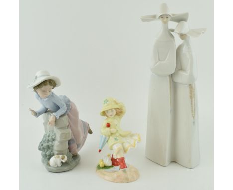 A Lladro figure of two nuns, 33cm tall, a Nao girl with a puppy and a Royal Doulton Follow Me figure (3).  In good condition 