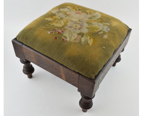 An antique footstool with tapestry decoration to top. Height 23cm.  