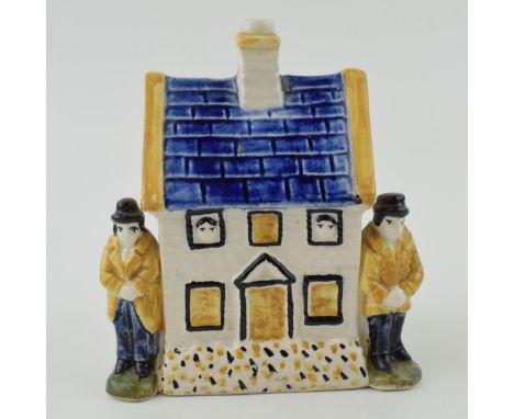 Prattware money box in the form of a house with two figures either side. Height 12.5cm.  