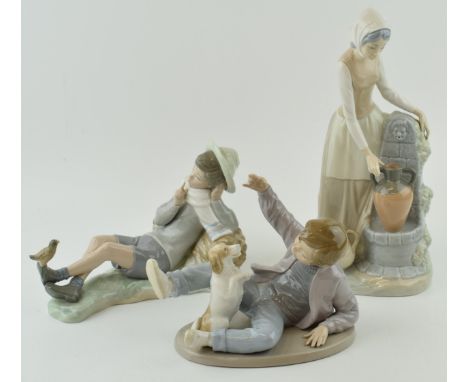 A trio of figures to include a Lladro boy with a bird on his foot (bird glued back), with a pair of Nao figures to include a 