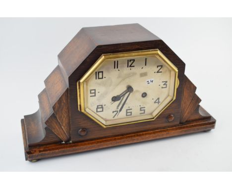 An Art Deco mantle clock with chiming movement. With pendulum and key. Height 20cm.  winds, runs and ticks down.