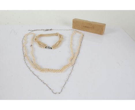 Collection of simulated pearl necklaces, one consisting of three rows of pearls together with a miniature carved figure house