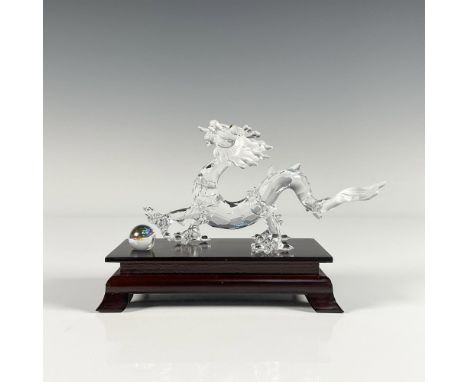 Lead crystal dragon made with frosted crystal tail. It sits with its crystal moveable ball on base. Part of the Fables and Ta