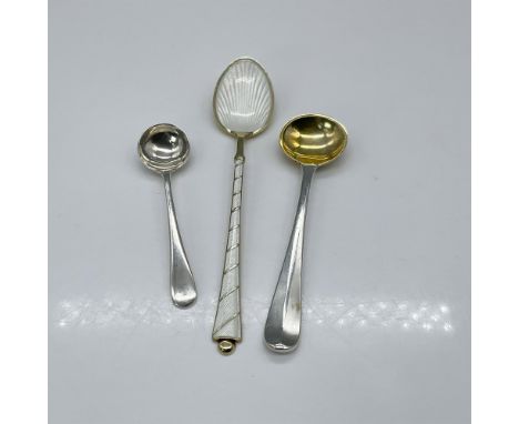 Elegant silver spoons, one adorned with pearlescent enamel decoration, and two featuring ladle-shaped heads, possibly for a s