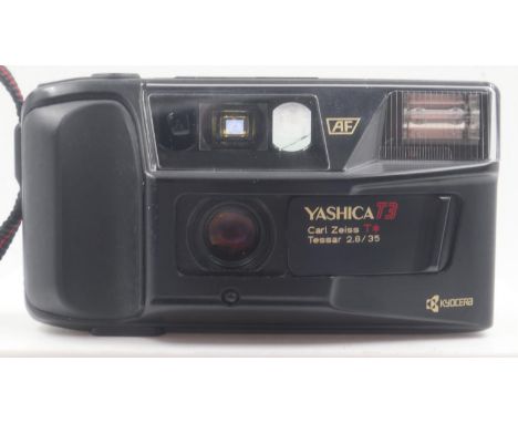 Yashica T3D 35 mm film camera. No sign of battery leakage, lens seems intact with no damages, case would benefit from a clean