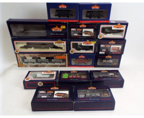 Sixteen 00 gauge Bachmann boxed goods wagons and boogie bolster wagons 