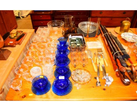 A large quantity of various glassware to include sundae dishes, bowls, smoky glass tankards, a brass and glass light fittings