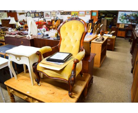 A Victorian button back armchair 