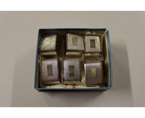 A set of six silver napkin rings with engine turned decoration