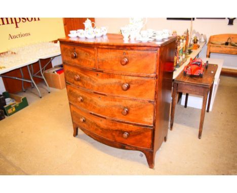 A 19th century mahogany and bow front chest fitted two short over three long drawers and raised on bracket feet 