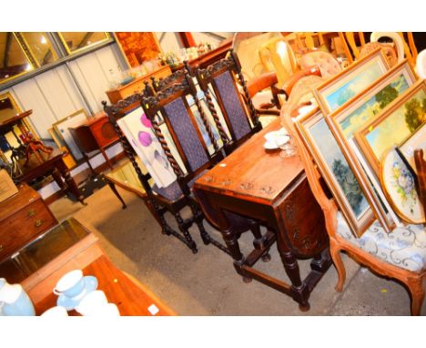 An oak gate leg dining table raised on turned supports; with a set of four oak barley twist dining chairs