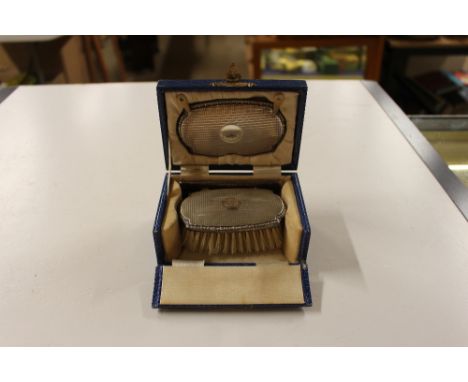 A silver mounted travelling grooming set comprising of a brush, mirror and comb, by Mappin & Webb