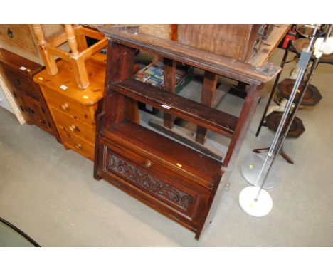 A carved mahogany wall shelf 