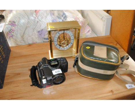 An Olympus AZ-330 super zoom digital camera and a Marks & Spencer's mantel clock