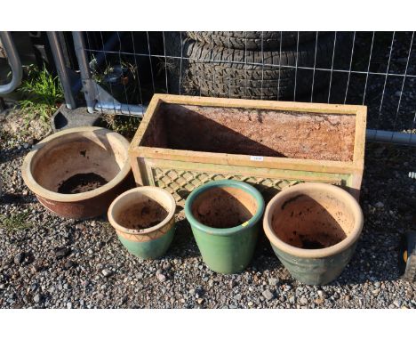 An oblong terracotta planter and four glazed planters
