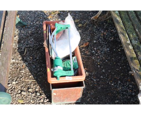 A garden sprinkler, various garden wire, copper planter etc.
