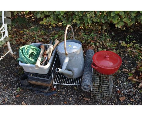 A quantity of seed trays, wire fencing, metal trap, galvanised watering can, various gardening tools