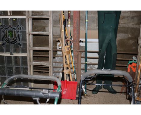 A bundle of long handled gardening tools