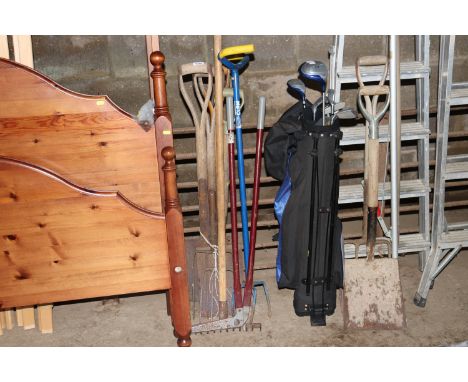 A bundle of long handled gardening tools