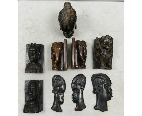 A collection of carved African book ends, wall masks together with a bust. Height of tallest 21cm 