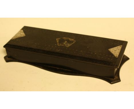 An Edwardian silver mounted ebony games box, hinged cover drilled for cribbage, shaped base, 25.5cm wide, London 1909