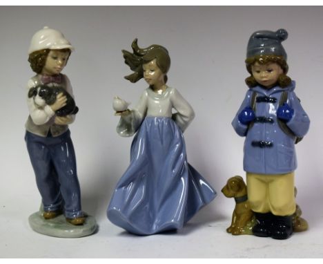 A Nao figure of a Young Girl with a puppy; another Boy in a Duffle Coat with a dog; another Young Girl with a dove (3)