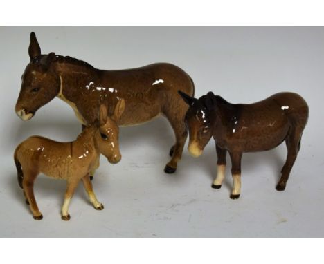 A Beswick model of a Donkey, 13cm; others, Donkey Foal and an Ass (3)