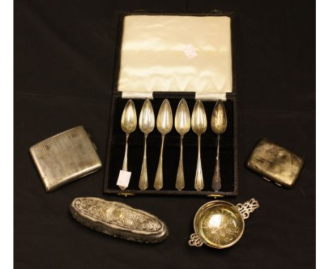 A set of six silver grapefruit spoons, cased; a silver engine turned cigarette case; another; a silver tea strainer and stand