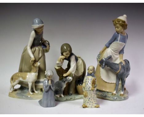 A Lladro figure girl stroking a seated dog, ND1246, caeres and rest, designed by Juan Huerta, retired 1990, others similar Na