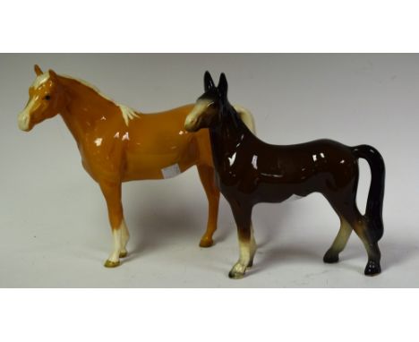 A Beswick model of a palomino horse standing;  another unmarked (2)