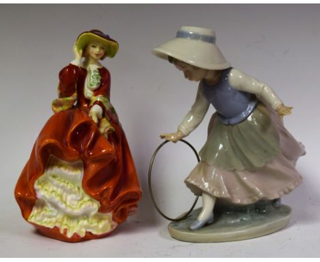 Ceramics - a Royal Doulton figure, Top o' the Hill; a Nao figure, Girl with Hoop (2)