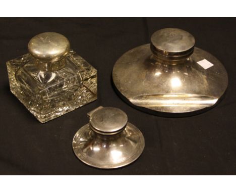 A large George V silver capstan inkwell, hinged cover, pen rest to base, 16.5cm diam, William Neale, Birmingham 1930; other s