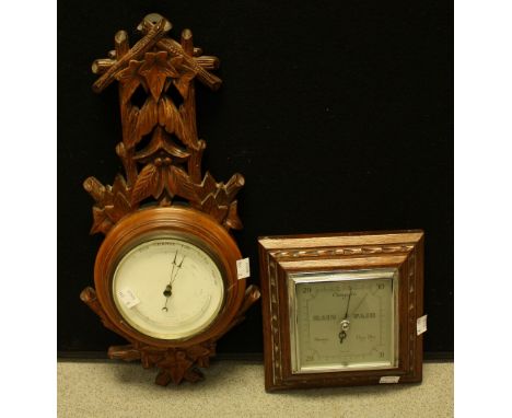 A Black Forest aneroid barometer, c.1900; an oak barometer (2)