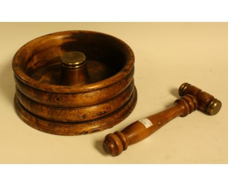 A hardwood nutcracker, ribbed circular holder, brass mounted gavel
