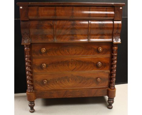 A Victorian mahogany 'Scotch' chest, hipped rectangular top above an arrangement of drawers flanked by spirally turned pilast