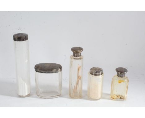 Five silver lidded clear glass dressing table bottles and pots, all initialled MC (5)