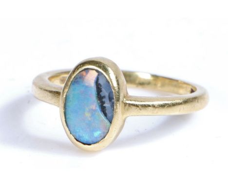 A 18 carat gold and opal ring, the head set with a oval opal AF, ring size R weight 5.1 grams&nbsp;