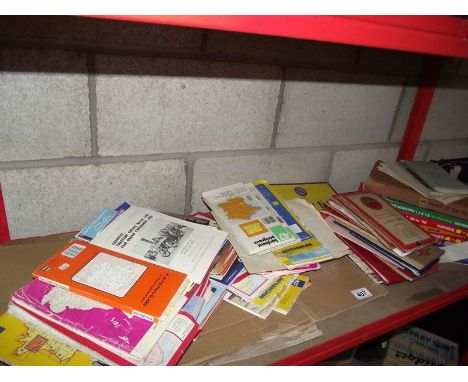 A shelf of old maps and workshop manuals.